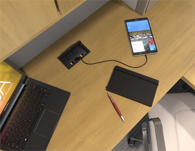 Top view rendering of a cubicle workspace with a flip top style ECA power hub providing power to devices on the desk.