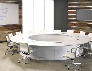 A rendering of a large circular white meeting table in a business conference room with whiteboard and projection screen.